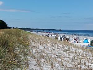 a beach with chairs and tables and the ocean at Ostseemeerchen in Zingst
