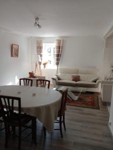 a living room with a table and chairs and a couch at Gîte Lagrave in Arette