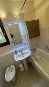 a bathroom with a sink and a toilet and a tub at Valberg Studio hyper centre in Valberg +7 photos