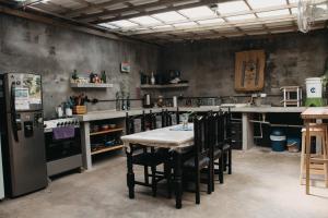 a kitchen with a table and chairs and a refrigerator at Casa Austera in El Paredón Buena Vista