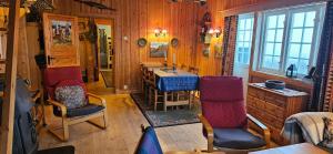 a room with a table and chairs in a house at Einsetlie by Norgesbooking - cabin by Hallingskarvet in Hovet