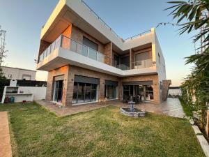 a large house with a yard in front of it at villa lux in Kenitra