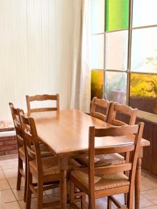 a wooden table and chairs in a room with a window at Casa Coronel in Mendoza