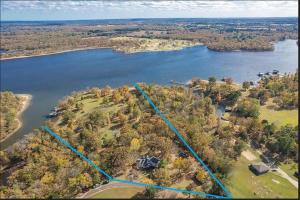 an aerial view of an island in a lake at Entire lake house at Lake Fork with private bay, boat ramp, fishing light & 8 acres land in Alba