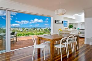 a kitchen and dining room with a table and chairs at The City Cottage in Auckland