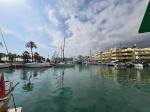 een jachthaven met boten in het water en appartementen bij Benalmadena Minerva Apartamento con gran piscina in Benalmádena
