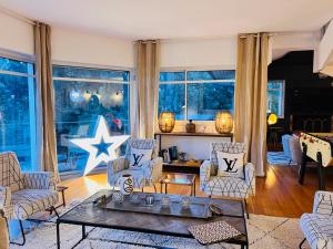 a living room with chairs and a table at Villa Sand Golf by Carlon Luxury Rentals in Seignosse