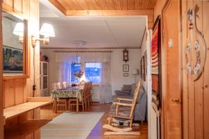 a kitchen and dining room with a table and chairs at Villa Blue in Autti