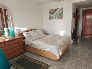 a bedroom with a bed with a dresser and a mirror at Best4Buck in Los Cristianos +11 photos