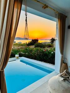 a view of a swimming pool through a window at Dreamy Sunset Villa a few steps from the Beach in Pounda +6 photos