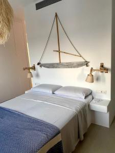 a bedroom with a bed with a boat hanging on the wall at Dreamy Sunset Villa a few steps from the Beach in Pounda