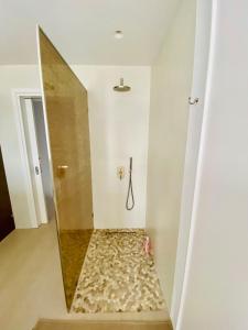a bathroom with a shower with a mirror at Dreamy Sunset Villa a few steps from the Beach in Pounda