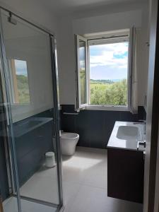 a bathroom with a shower and a sink and a window at Dimora Fonte San Pietro in Civitanova Marche