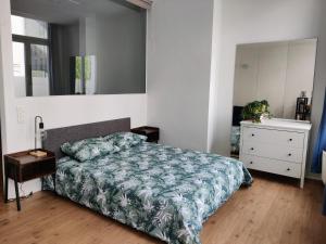 a bedroom with a bed and a dresser and a mirror at Nice Flat Grand Place in Brussels +1 photo