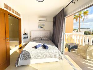 a bedroom with a bed and a balcony at Villa Callao Salvaje 3 BR Heated Pool & Stunning Views in Adeje +68 photos