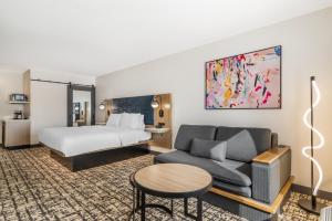 a hotel room with a bed and a couch at Hampton Inn Atlanta-Stockbridge in Stockbridge