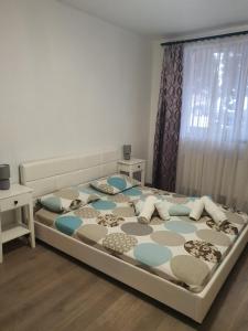 a bedroom with a large bed with pillows on it at Apartament Mara in Alba Iulia