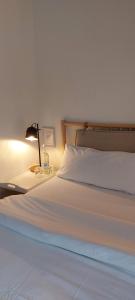 a bedroom with a bed with a lamp on a table at Gästehaus 22 am Klostergarten in Rehna