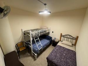 a bedroom with two bunk beds and a bed at Casa Zocalo in Mexico City