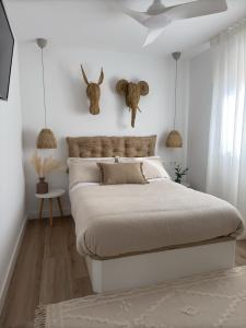 a bedroom with a large bed with white walls at Apartamento La Gata del Cabo in El Cabo de Gata