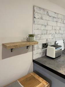 a counter with a toaster and a toaster oven at Willden Cottage in Holmfirth