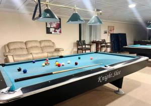 a pool table with balls on it in a living room at Familiar Partition Room In Tecom Near ICM Metro in Dubai