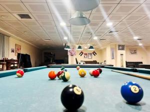 a pool table with balls on top of it at Familiar Partition Room In Tecom Near ICM Metro in Dubai
