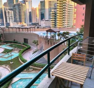 a balcony with a bench and a view of a city at Familiar Partition Room In Tecom Near ICM Metro in Dubai