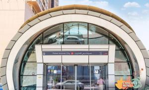 a building with a sign in front of it at Familiar Partition Room In Tecom Near ICM Metro in Dubai