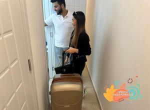a man and a woman standing next to a suitcase at Familiar Partition Room In Tecom Near ICM Metro in Dubai