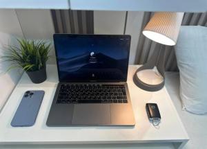 a laptop computer sitting on top of a desk at Familiar Partition Room In Tecom Near ICM Metro in Dubai