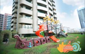 a playground in front of a tall building at Familiar Partition Room In Tecom Near ICM Metro in Dubai