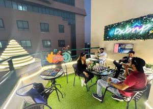 a group of people sitting in chairs in a building at Familiar Partition Room In Tecom Near ICM Metro in Dubai