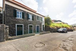 een huis met een auto ervoor geparkeerd bij Casa da Avó Paraíso 1 in Machico