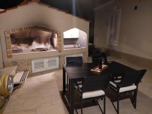 a kitchen with a table and chairs and a fireplace at Chill apartment in Dubrovnik