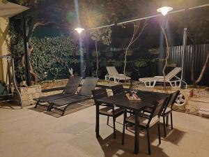 a table and chairs on a patio at night at Chill apartment in Dubrovnik