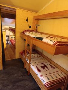 two bunk beds in a room with a mirror at La grange d'Alexandre 6 personnes in Val Cenis