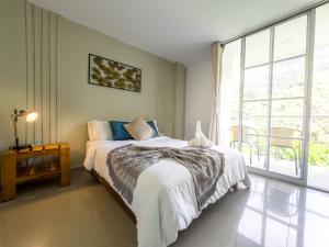 a bedroom with a bed and a large window at Montes De Beraka in Minca +46 photos