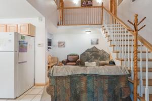 a kitchen with a staircase and a living room at Hope's Hideaway, LLC in Hope