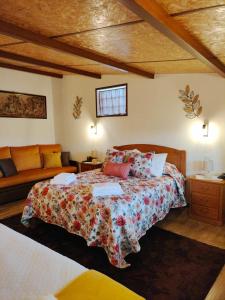 a bedroom with a bed and a couch at Casa da Vovó Luisa in Quinta da Lama Redonda +23 photos