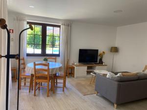 a living room with a table and a couch at Leiras da Cachada - Gerês in Valdosende