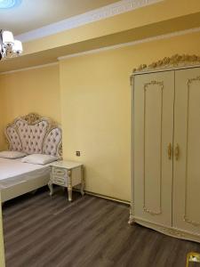 a bedroom with a bed and a dresser in a room at AL SHEIKH 5 BEDROOM LUXURY APARTMENT 1 in Yerevan +23 photos