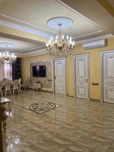 a large room with a chandelier and a dining room at AL SHEIKH 5 BEDROOM LUXURY APARTMENT 1 in Yerevan