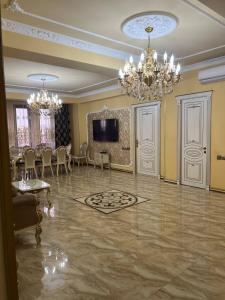 a large living room with a table and chandeliers at AL SHEIKH 5 BEDROOM LUXURY APARTMENT 1 in Yerevan