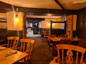 a dining room with wooden tables and chairs at The Ladybower Inn in Bamford +31 photos