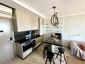 a kitchen with a counter and stools in a room at Luxury 2 Bedrooms Ocean View Iguazu in Playa del Ingles