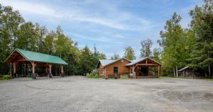 a log cabin with a green roof and a pavilion at Hope's Hideaway, LLC in Hope