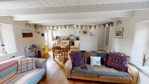 a living room with a couch and a table at Mrs Moll's Cottage in Earlston