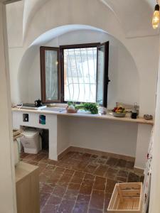 a kitchen with a counter and a window at Appartamentino nel castello in Miglianico