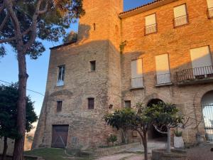 an old brick building with a tower on top at Appartamentino nel castello in Miglianico +18 photos